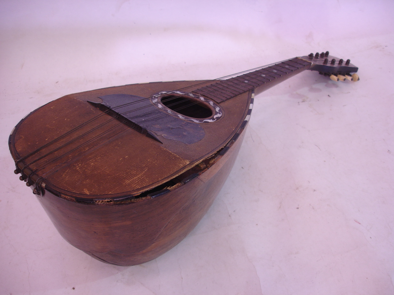A mandolin bears label for Michele Maratea. (Damage to front board and repairs to neck) 23" long