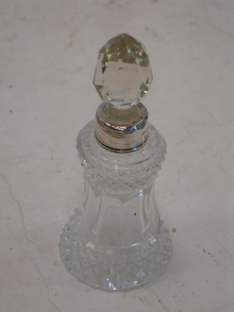 A silver mounted cut glass scent bottle, London 1928. 3 ½" high