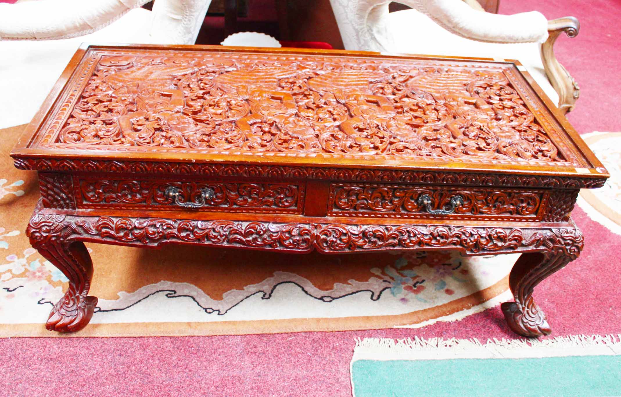 A RECTANGULAR CARVED SOUTH EAST ASIAN HARD WOOD OCCASIONAL TABLE, 
O.R.M., the top profusely