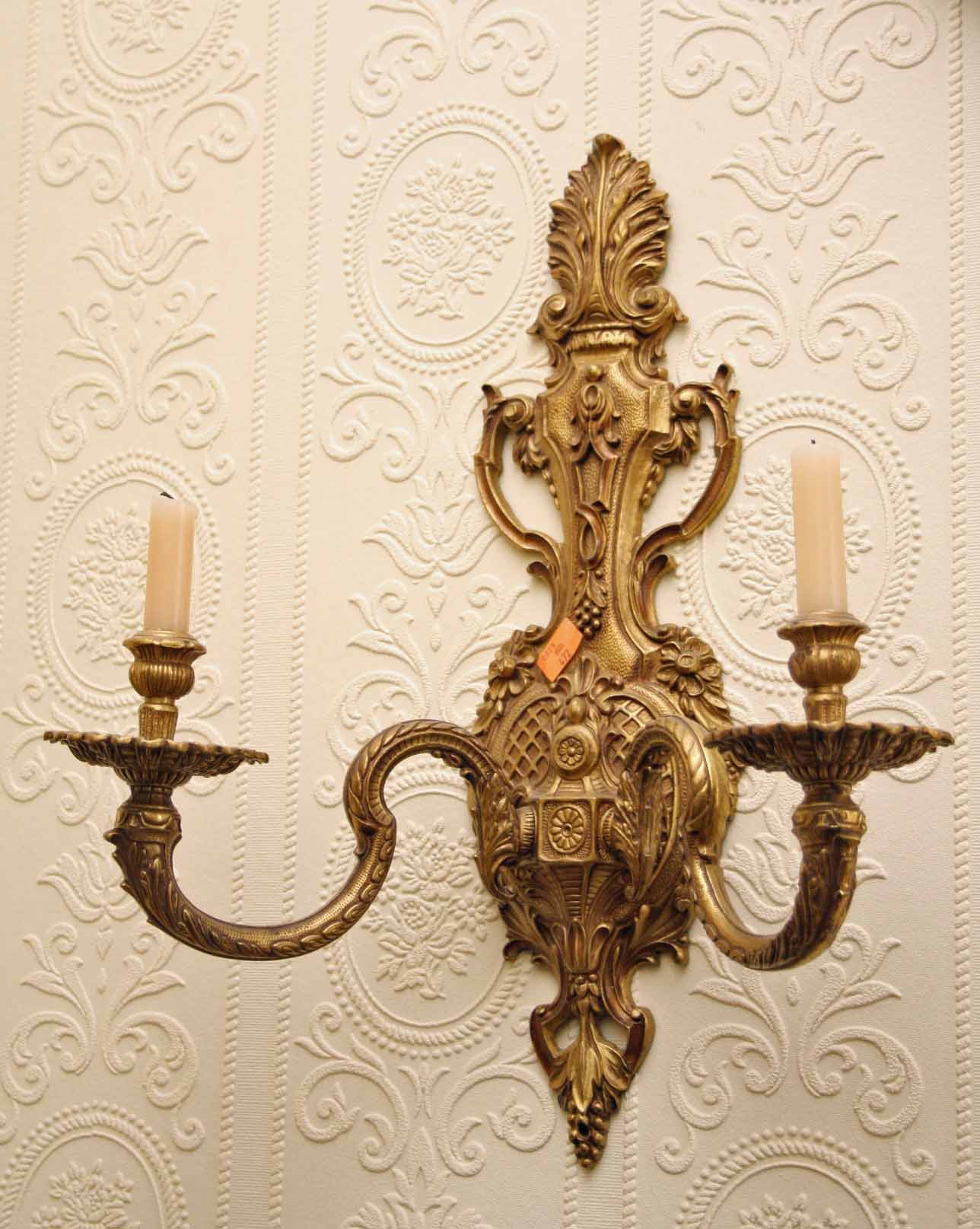 A PAIR OF GILT BRASS TWO BRANCH CANDLE SCONCES, 
Each with a leaf crest above a two-handled base