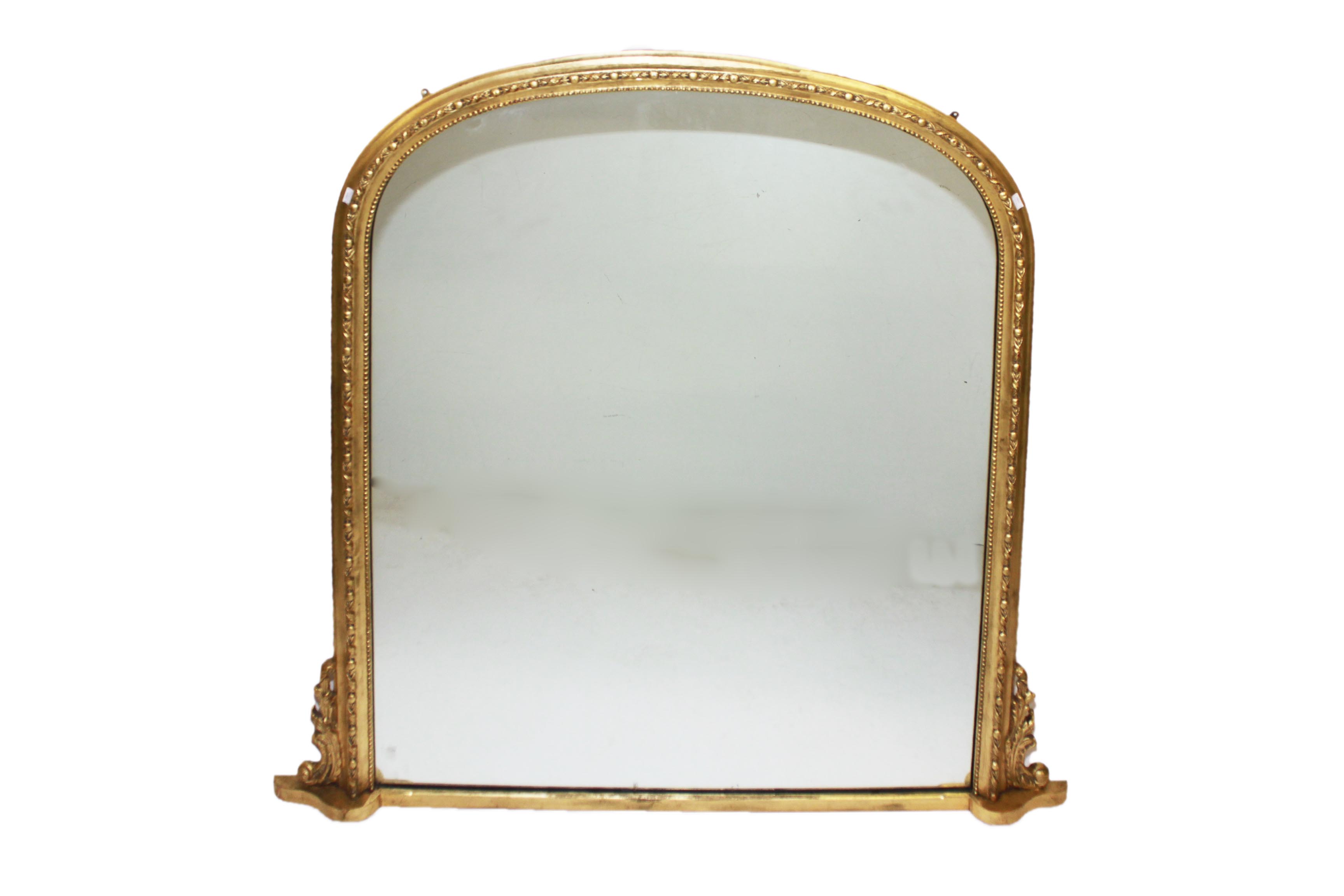 A GILT AND GESSO OVER MANTEL, 
ORM, in the Victorian style, the arch and moulded frame, around a