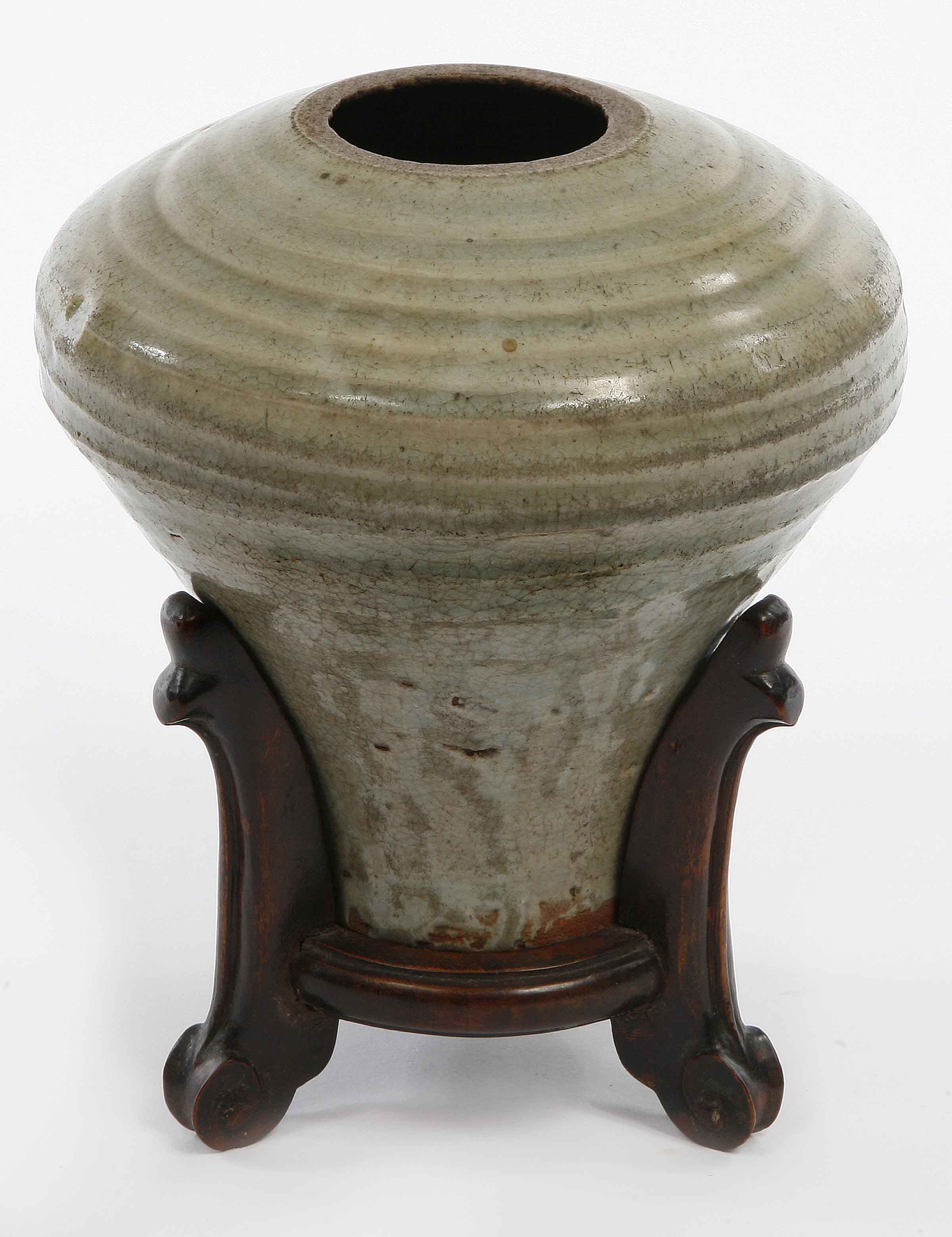 A CHINESE SONG STYLE EARTHENWARE ROUND STORAGE POT, with celadon glaze, 8in (20cm) high, on a