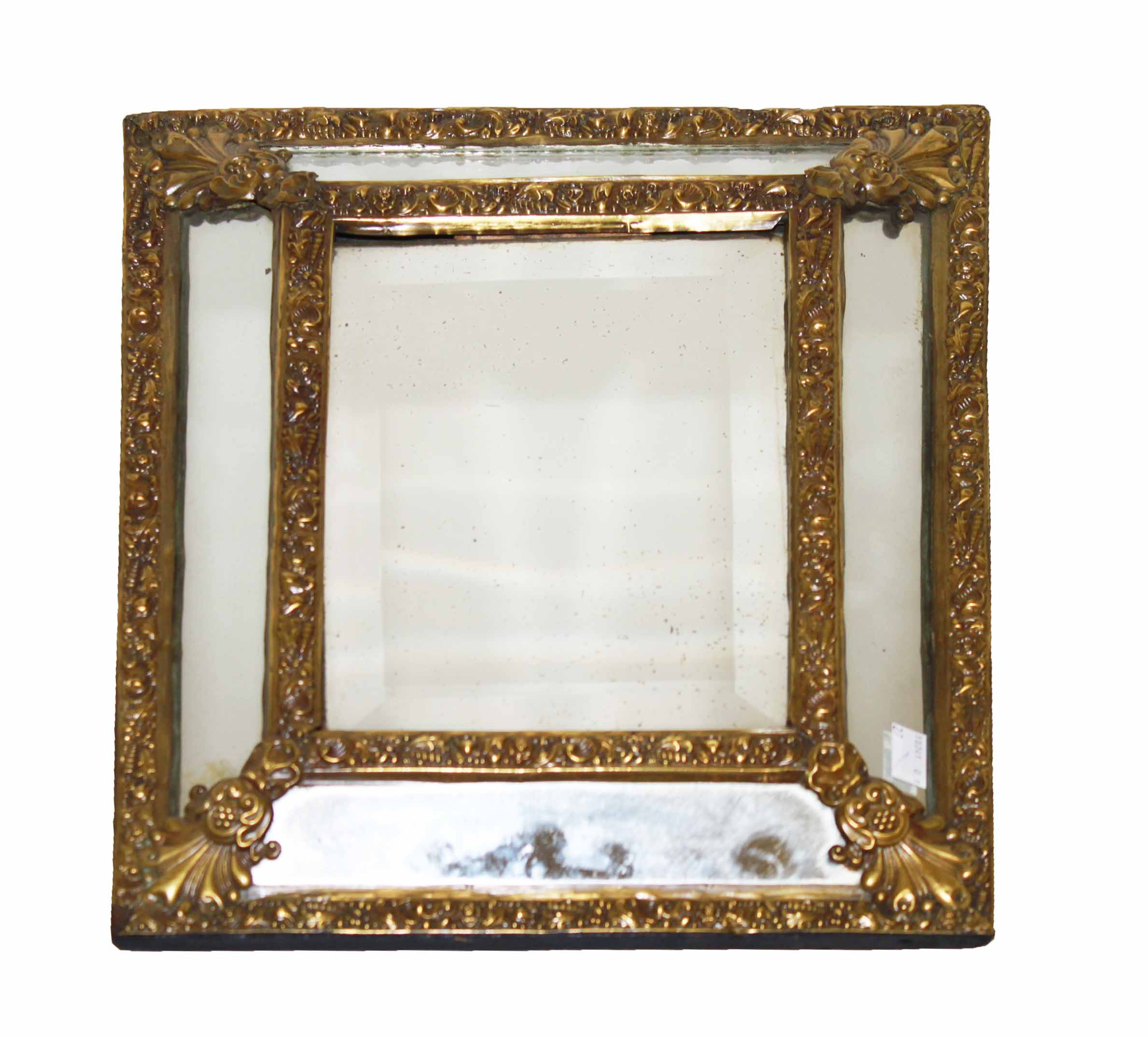 A VENETIAN EMBOSSED BRASS CUSHION FRAMED MIRROR, 
with five plates, 16in(141cm)hx 13in(33cm)w. (1)