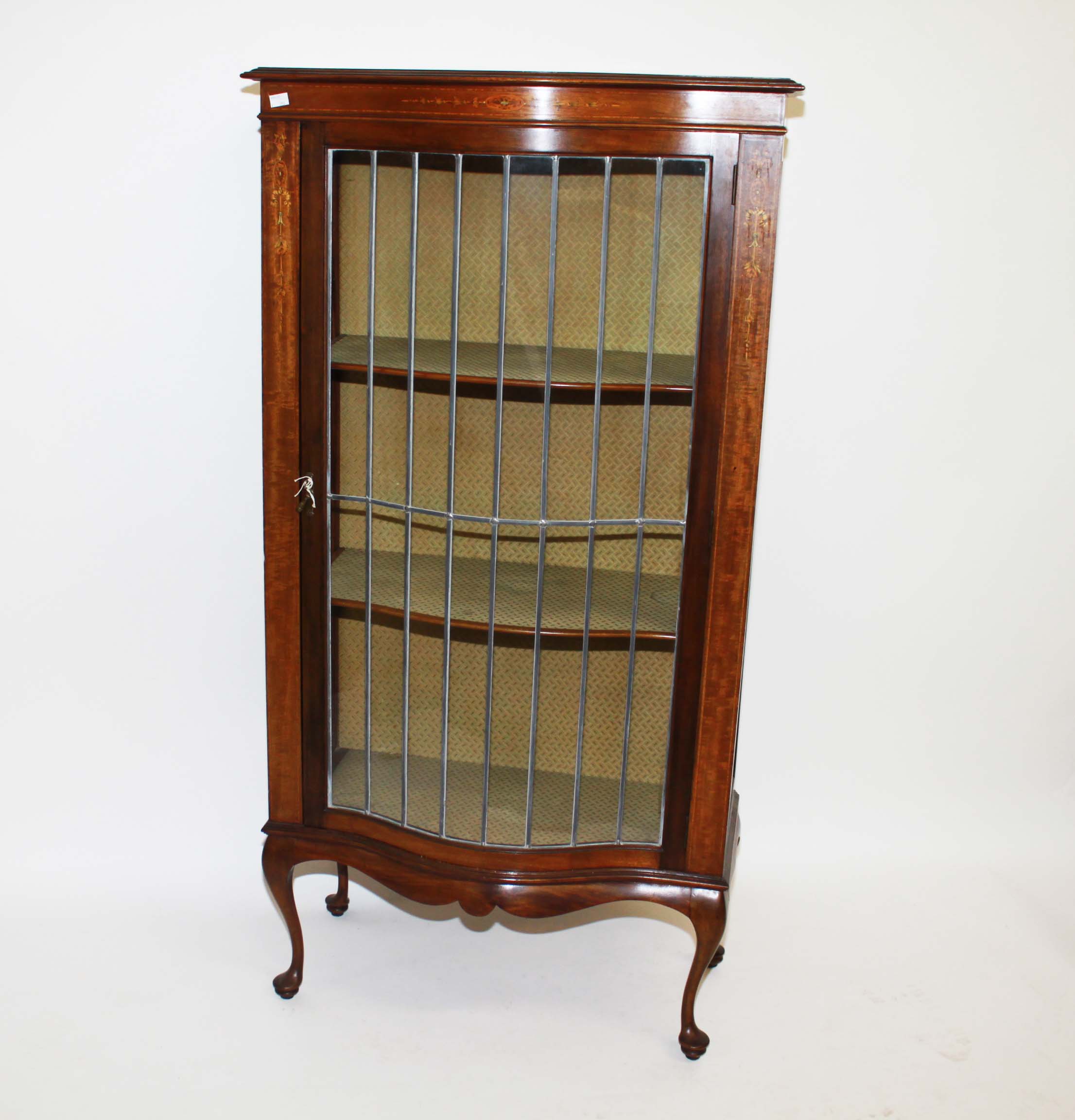 A MAHOGANY SERPENTINE FRONTED MARQUETRY INLAID DISPLAY CABINET,
early 20th century, with one long