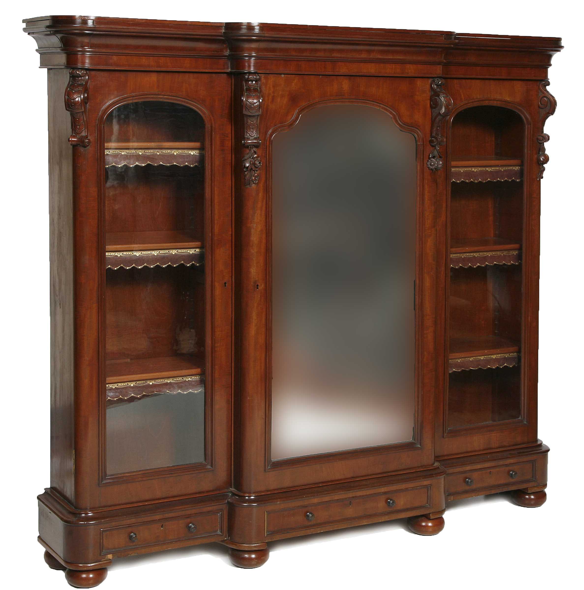 A MAHOGANY BREAKFRONT BOOKCASE,
mid 19th century, with moulded cornice and frieze, the central