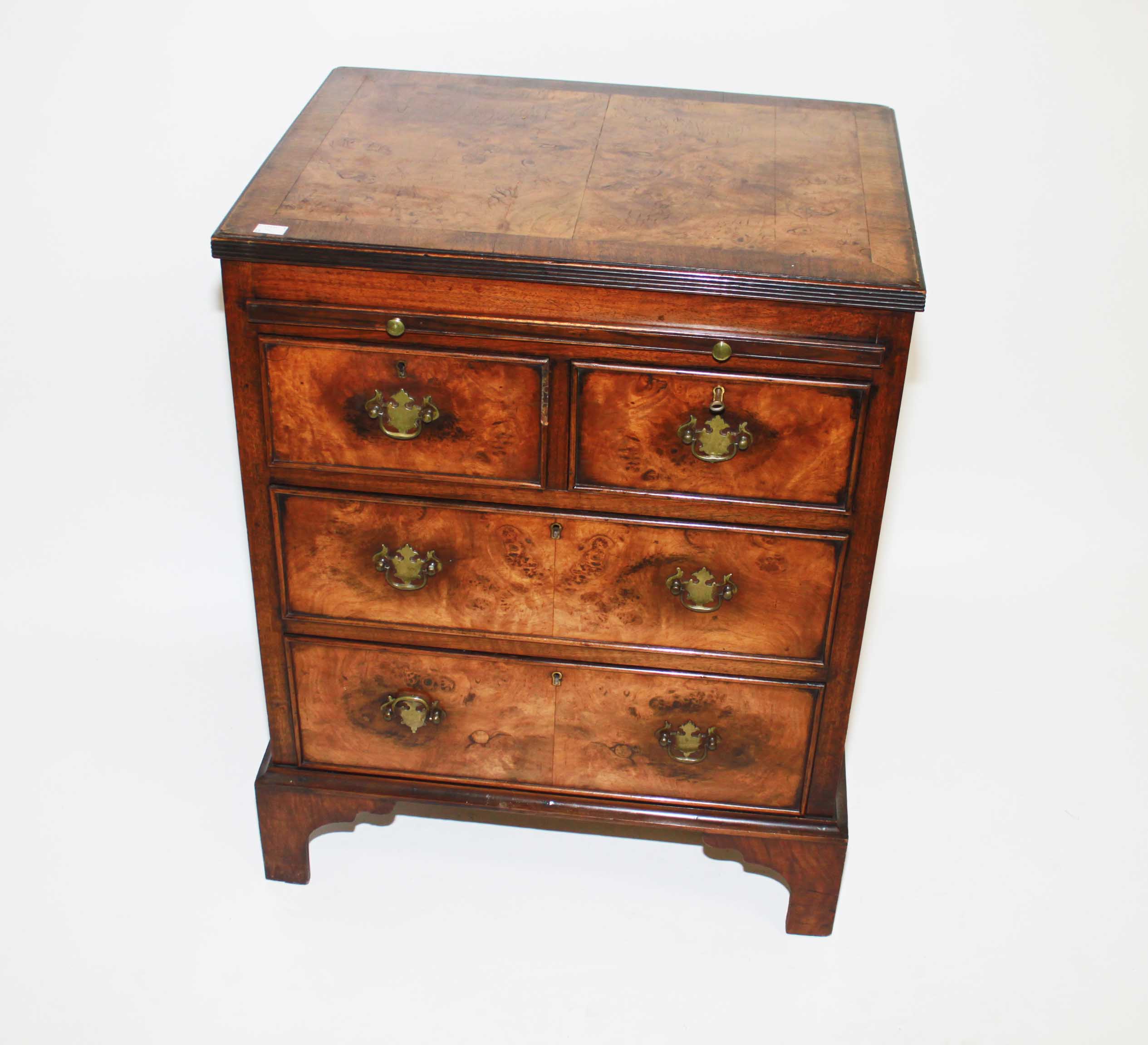 A WALNUT AND CROSS BANDED CHEST,
in the early 18th century style, and of small proportions, with a