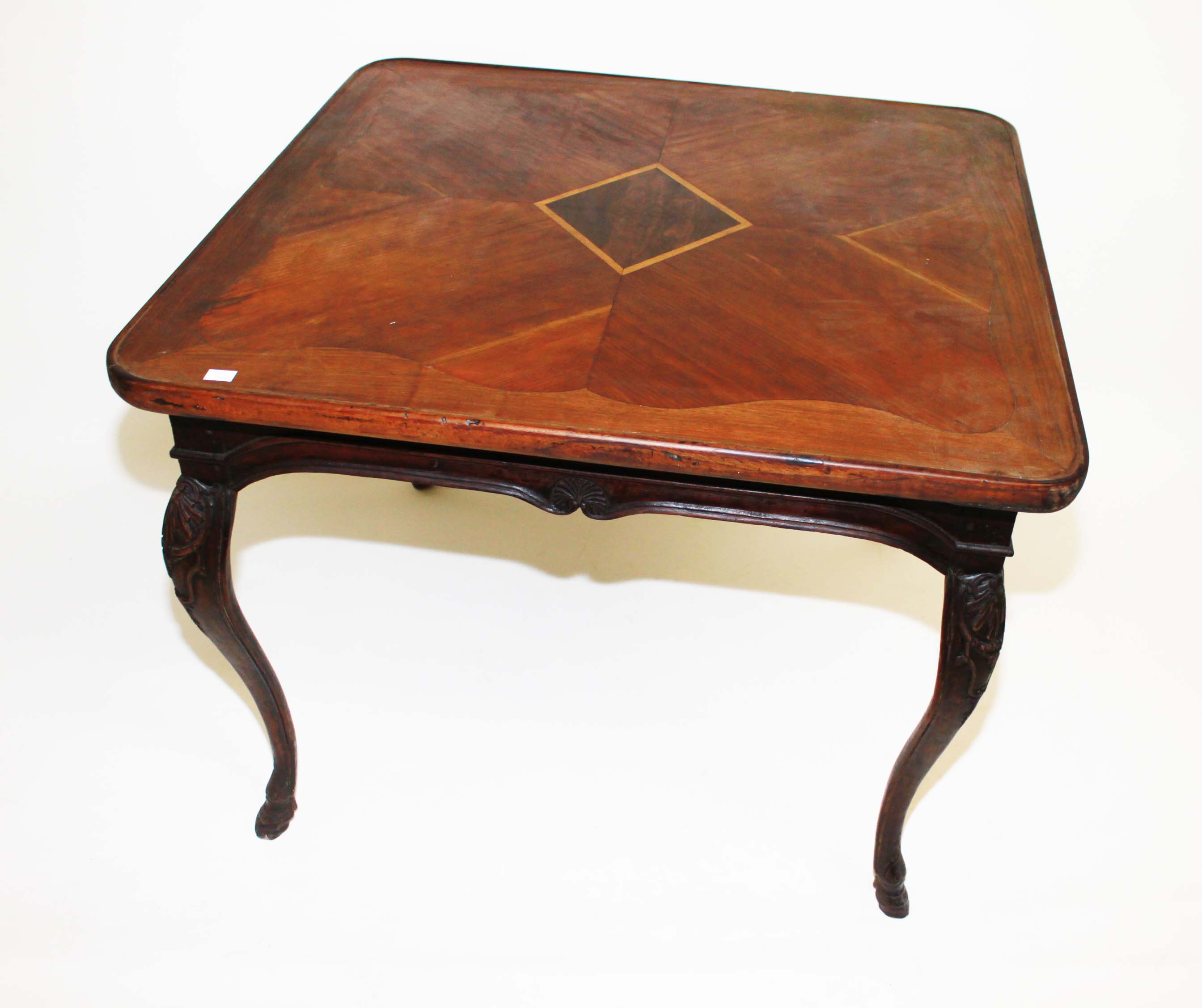 An Unusual Walnut Centre Table,
20th century, with segmented and cross banded square top, with