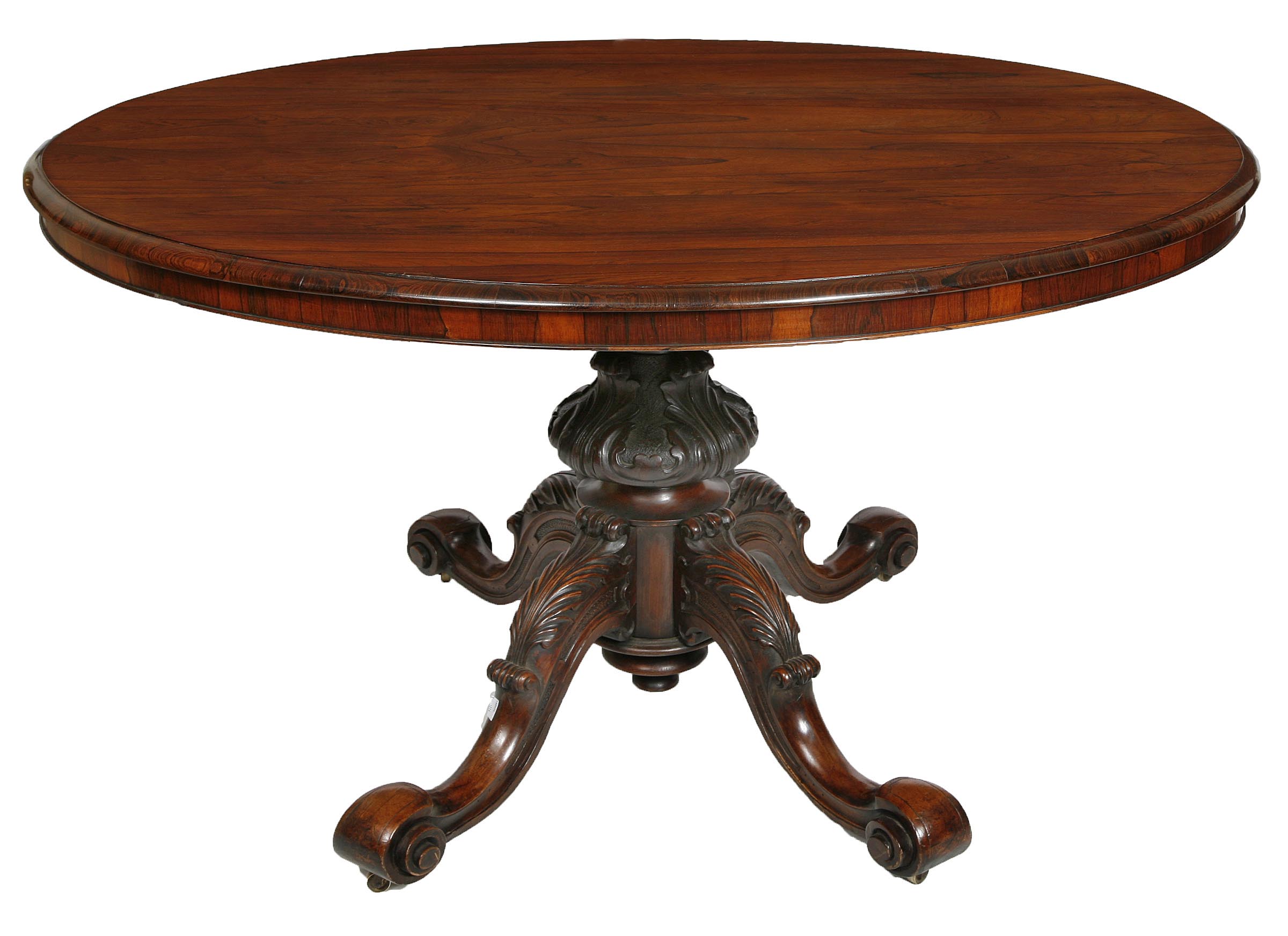 A ROSEWOOD OVAL TILT TOP TABLE,
19th century, with moulded rim and plain frieze on leaf carved