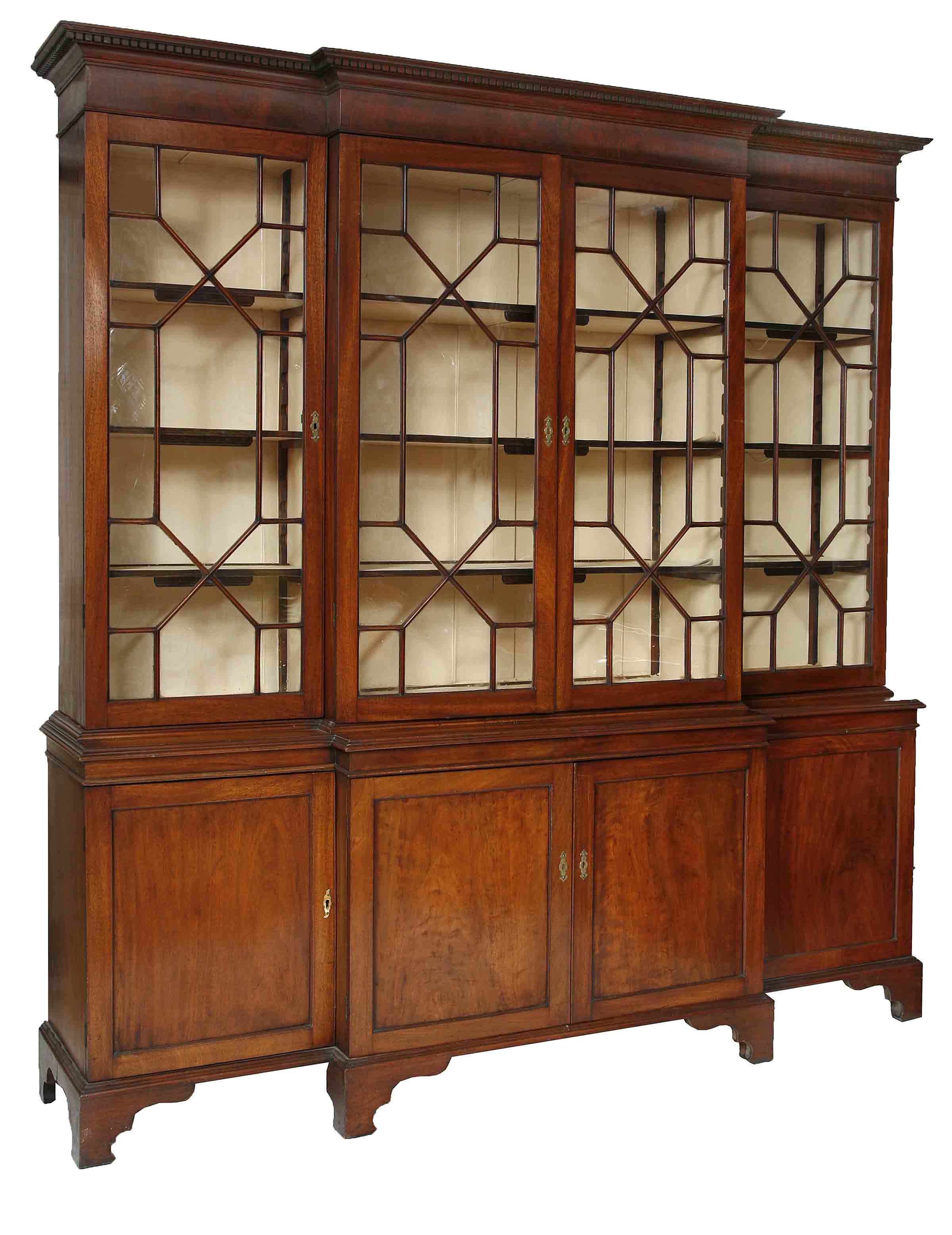 A MAHOGANY BREAKFRONT LIBRARY BOOKCASE, 
C.1900, in the George III style, with dentil moulded