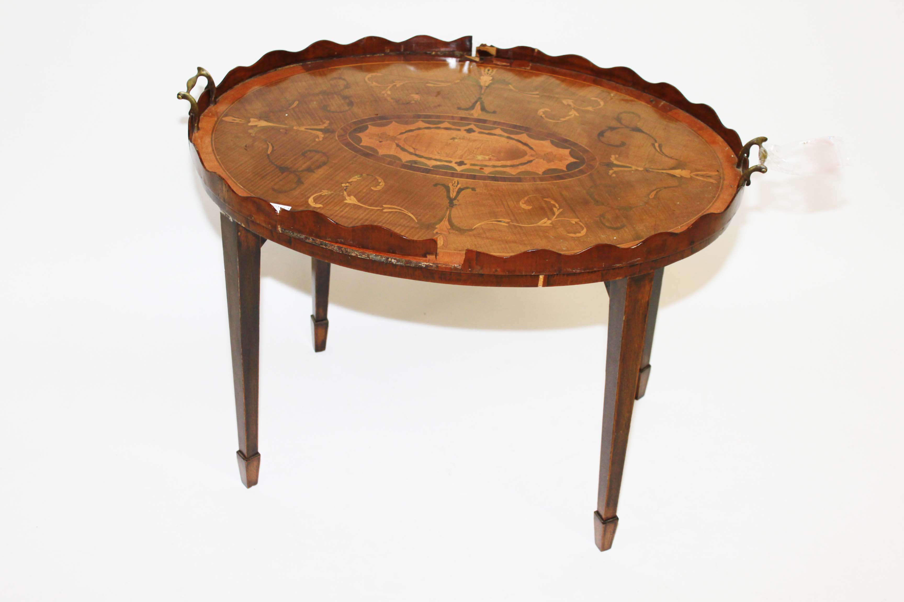 AN OVAL INLAID MAHOGANY TRAY, 
19th century, the marquetry top with a central monogram and two brass