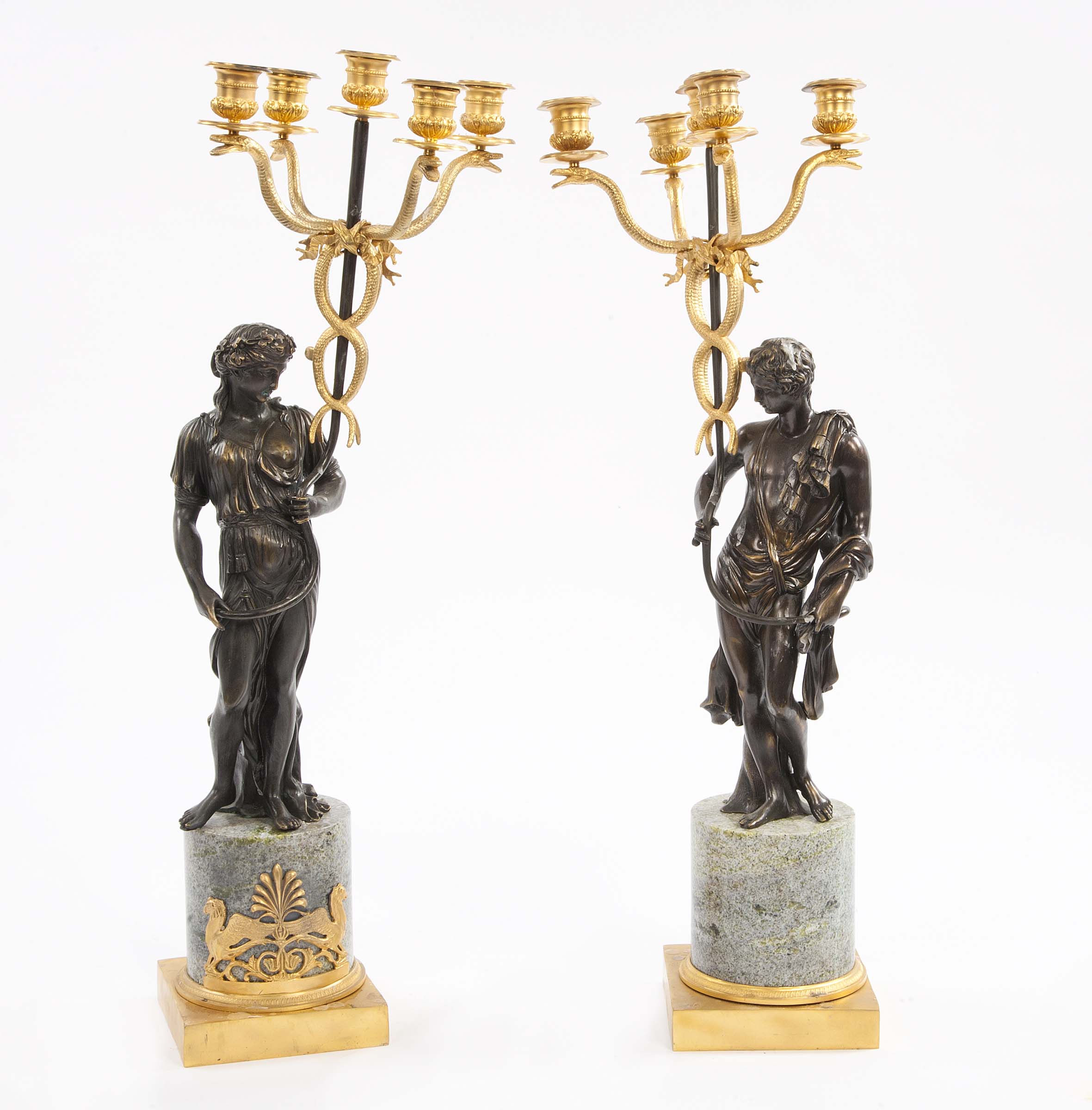 A PAIR OF BRONZE AND GILT BRONZE FIGURAL CANDELABRA, in the Regency style, O.R.M., each with four