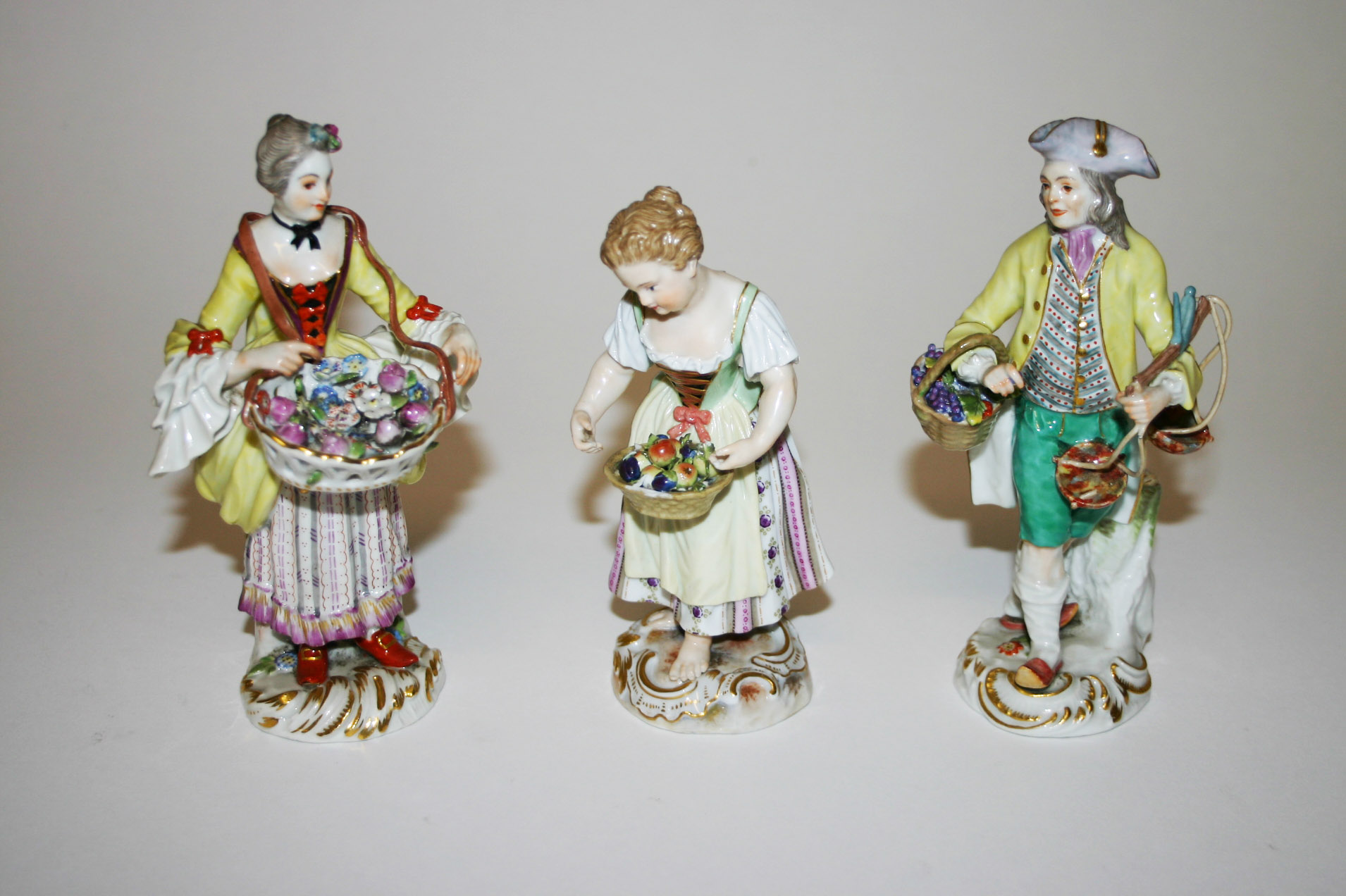 THREE SIMILAR MEISSEN PORCELAIN FIGURES, early 20th century, one modelled as a gentleman with basket