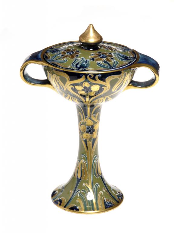 A JAMES MACINTYRE & CO GREEN AND GOLD FLORIAN WARE VASE AND COVER DESIGNED BY WILLIAM MOORCROFT 22cm