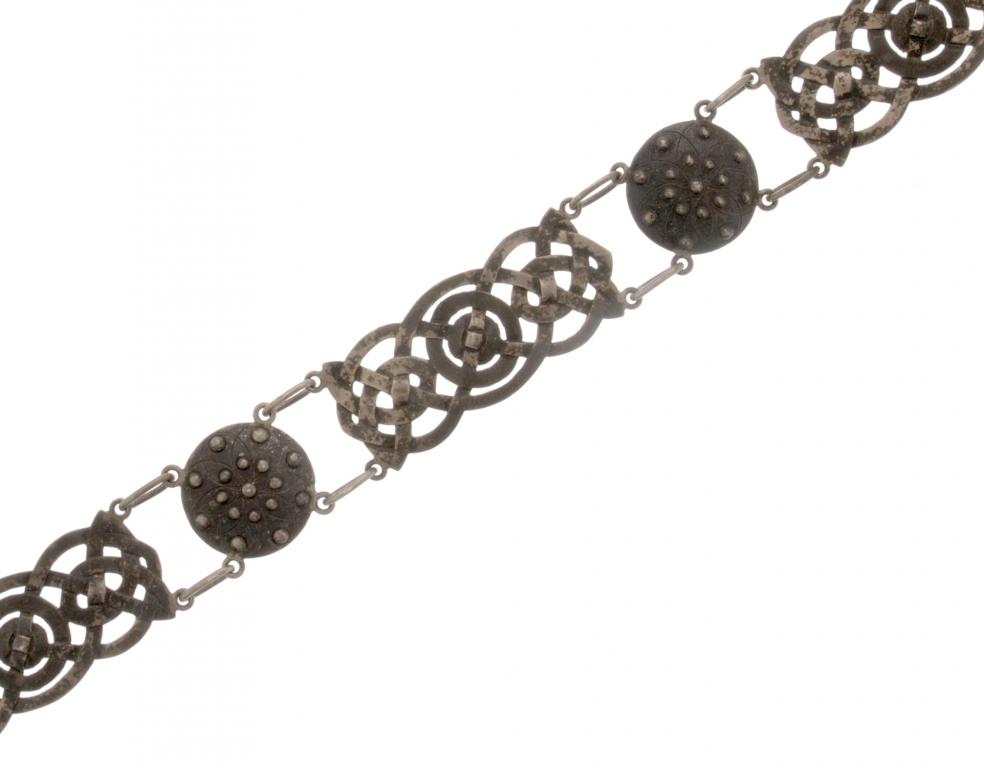 A SCOTTISH CELTIC REVIVAL SILVER BELT of links of entrelac alternating with a targe, 68cm l, by