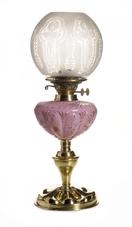 A VICTORIAN BRASS OIL LAMP with enamelled and spirally lobed pink glass fount and brass burner, on