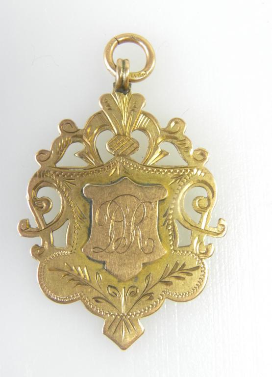 A 9CT GOLD PIERCED FOB SHIELD ENGRAVED AS A BOXING PRIZE, MANSTON 1921, BIRMINGHAM 1900, 7G