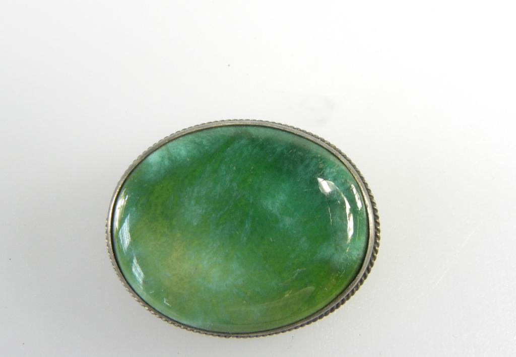 A CHARLES HORNER OVAL SILVER BROOCH SET WITH A RUSKIN POTTERY GREEN GLAZED PLAQUE, MAKERS MARK