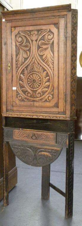 A 19TH C CARVED OAK CORNER CUPBOARD ON STAND WITH DRAWER AND APRON