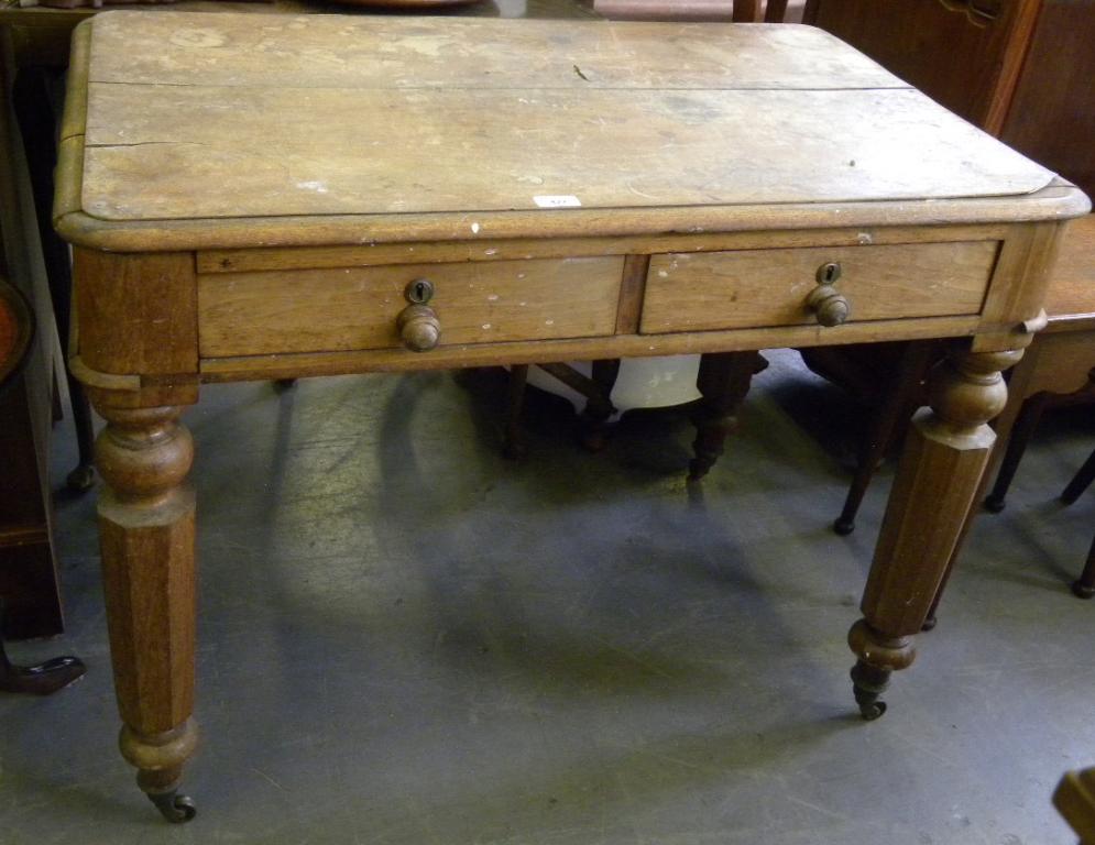 A VICTORIAN MAHOGANY WRITING TABLE FITTED TWO DRAWERS, ONE SIDE WITH A PIVOTED INK DRAWER ON