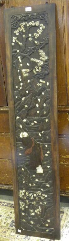 A JAPANESE CARVED WOOD, LACQUER AND MOTHER OF PEARL PANEL DEPICTING A MAN AND BLOSSOMING TREES IN