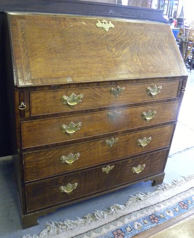 A GEORGE III INLAID OAK BUREAU WITH BRASS KEY PLATES AND HANDLES