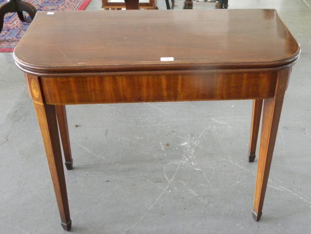 A GEORGE III INLAID MAHOGANY CARD TABLE ON SQUARE TAPERED LEGS
