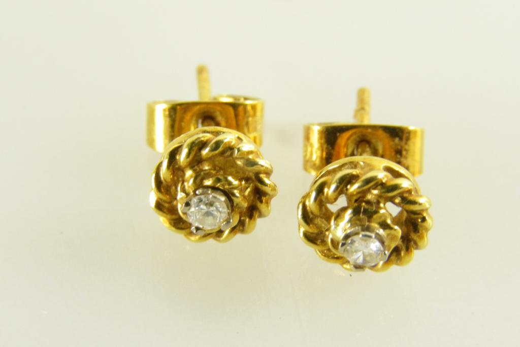 A PAIR OF DIAMOND AND GOLD KNOT EAR STUDS