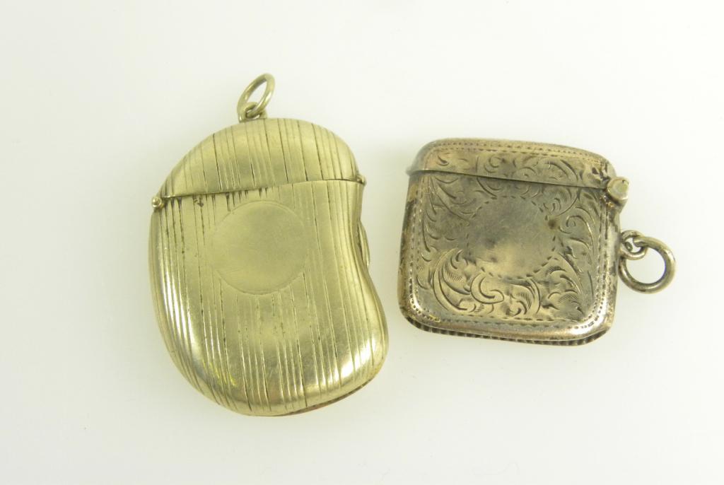 A SILVER VESTA CASE, BIRMINGHAM 1914 AND AN EDWARDIAN EPNS BEAN SHAPED VESTA CASE, ENGINE TURNED