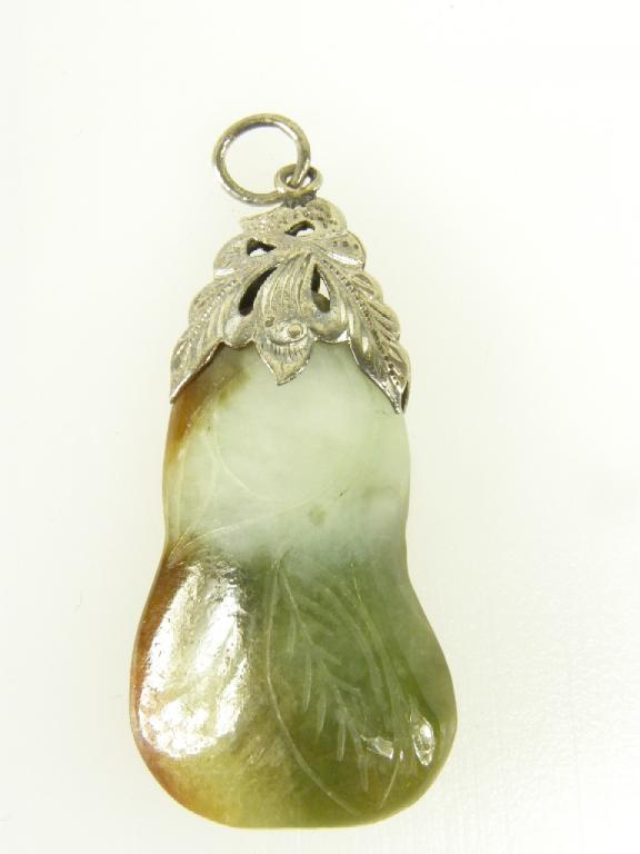 A JADE PENDANT, THE PEBBLE CARVED WITH LEAVES, SILVER MOUNT