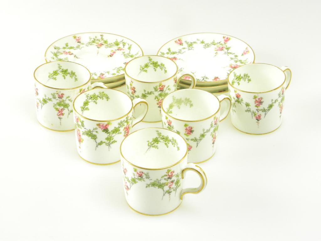 A SET OF SIX ROYAL CROWN DERBY COFFEE CANS AND SAUCERS DECORATED WITH ROSE PENDANTS AND SWAGS,