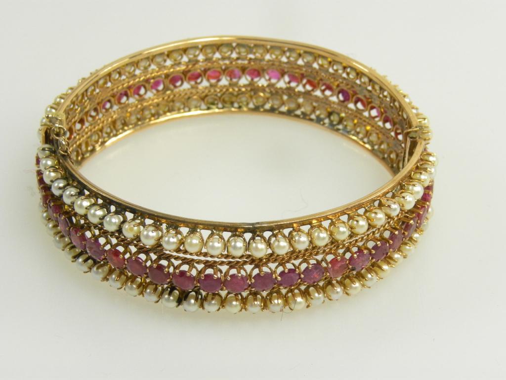 A RUBY AND CULTURED PEARL THREE ROW BRACELET IN GOLD, 32G GROSS