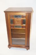 A cabinet with a glazed and mirror door