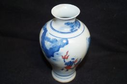 An oriental blue and white vase with Kangxi mark to the base