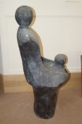 A large stone figure of a mother and child in the style of Henry Moore. Marked "H. Moore, Exhibition