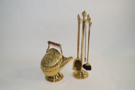 A brass coal scuttle and fire companion set