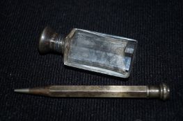 A perfume bottle with a silver lid, along with a propelling pencil marked "sterling silver"