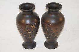 A pair of early 20th century Japanese bronzes vases of baluster form, decorated with bird and tree