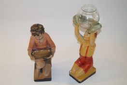 Two early 20th Century ceramic figures, one of a boy the other of a seated girl.