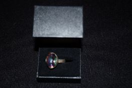 A silver and peacock colour quartz ring