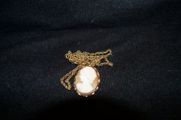 A shell cameo pendant and chain