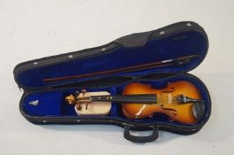 A cased half size Violin