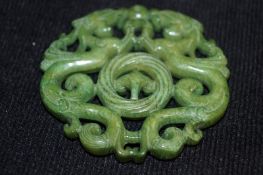 A carved jade pendant of two dragons