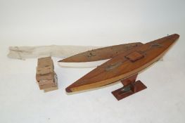 Two large hand made wooden boats , along with sails and various other parts