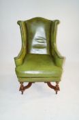 A green leather chair in a Jacobean style
