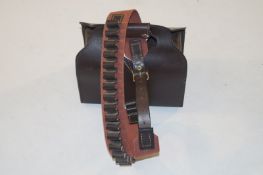 A Brady 20 gauge cartridge belt and a leather bag