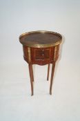 A reproduction galleried drum table