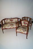 An Art Nouveau salon suite, comprising of two seater and two singles decorated with clovers