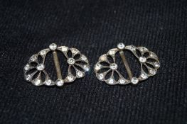A pair of silver and Faux Diamond buckles