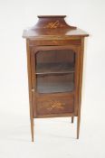 A glazed and inlaid cabinet