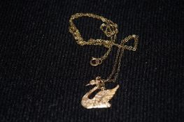A 9ct gold swan pendant